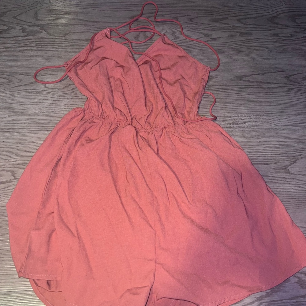 Pink romper/jumper with criss cross backing